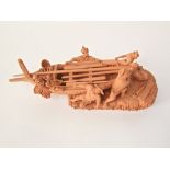 An unusual Italian terracotta model of a fishing boat being launched by four fishermen, with incised
