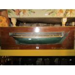 A vintage half hull model of a galleon with painted finish raised on a rectangular plaque with