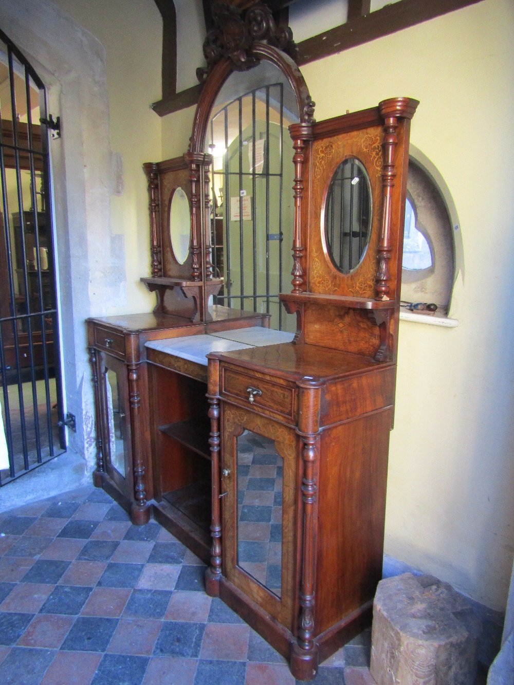 A Victorian figured walnut inverted break front chiffonier or side cabinet, the lower section