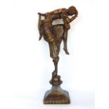 Art deco style cast bronze figure of a dancer, in robes with serpent at her feet, 60cm high