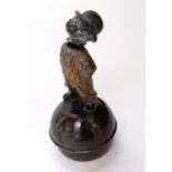 19th century money box, the globular base surmounted by a street urchin with nodding head 16 cm