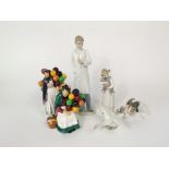 A Lladro model of a terrier examining a butterfly on its tail, a Lladro figure of a little girl