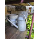 A small reclaimed galvanized steel water tank/cistern with pop riveted seams together with vintage