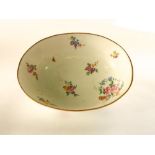 A 19th century continental bowl of oval form in the sevres manner with polychrome painted floral