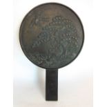 Oriental bronze hand mirror, decorated in relief with cranes and turtles, 27 cm long