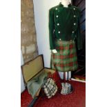 A suitcase containing three Scottish tartan men's kilts from J Morrison, Edinburgh, together with