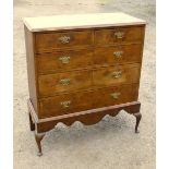 GEORGE V CROSSBANDED WALNUT CHEST WITH TWO SHORT AND THREE GRADUATED LONG DRAWERS ON A STAND ON