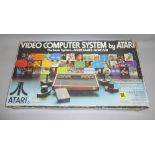 BOXED VIDEO COMPUTER SYSTEM BY ATARI MODEL No. CX-2600 TOGETHER WITH GAMES INCLUDING 'STREET RACER',