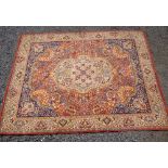 AXMINSTER PERSIAN PATTERNED CARPET WITH A CENTRAL MEDALLION ON A MADDER AND INDIGO FIELD (356 cm x