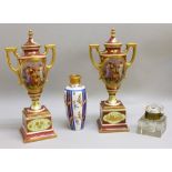 A MATCHED PAIR OF VIENNESE PORCELAIN RED AND GILT FLORAL BALUSTER TWO HANDLED VASES EACH WITH A