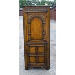 A GOOD REPRODUCTION CARVED ELM CORNER CUPBOARD WITH AN ARCHED PANELLED DOOR ABOVE, QUADRUPLED