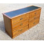 EDWARDIAN STYLE WALNUT CHEST WITH A GILT TOOLED LEATHER INSET TOP AND THREE PAIRS OF REEDED