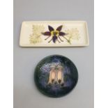 A MOORCROFT AQUILEGIA OBLONG TRAY ON A CREAM CROUND, IMPRESSED MARK AND A CIRCULAR MOORCROFT PIN