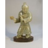 A CHINESE GREEN MOTTLED JADE FIGURE OF A MAN HOLDING A CUP IN HIS RIGHT HAND (H: 17.3 cm OVERALL)