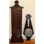 AN ART DECO ANEROID WHEEL BAROMETER AND THERMOMETER IN A CARVED OAK CASE (H: 72 cm) AND AN OAK CLOCK