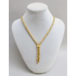 AN 18ct YELLOW AND WHITE GOLD ROPE TWIST NECKLACE WITH A TOGGLE AND TASSLE DROPS, LENGTH APPROX.