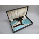 A 1920's CHROME AND GUILLOCHE ENAMEL STYLED DRESSING TABLE SET COMPRISING HAND MIRROR, HAIRBRUSH,