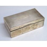 A SILVER CIGARETTE BOX WITH PRESENTATION ENGRAVING, LENGTH 17cm