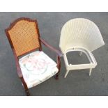 A LLOYD LOOM WHITE PAINTED WINGBACK CHAIR (75.5cm x 57cm) AND A MAHOGANY FINISH CANEBACK ARMCHAIR (