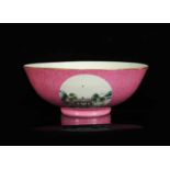 A polychrome porcelain medallion bowl with a decor of pavilions on a river on a pink ground in