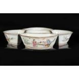 A five-piece polychrome porcelain condiment set with a decor of figures in a garden. Marked with