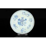 A blue and white porcelain dish with a decor of symbols. Marked with seal mark Jiaqing. In a box.