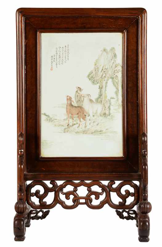 A wooden and porcelain table screen with a decor of goats and a story, which is a symbol of the city