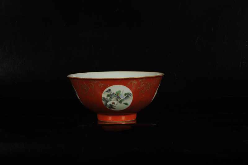 A red porcelain medallion bowl with a polychrome decor of several landscapes and gold colored floral - Image 2 of 3