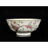 A polychrome porcelain bowl with a decor of peaches and cranes. Marked with six-character mark