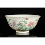 A polychrome porcelain bowl with a decor of flowers in a garden. Marked with six-character mark