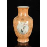 A polychrome porcelain baluster vase with a decor of medallions with flowers and birds. Marked