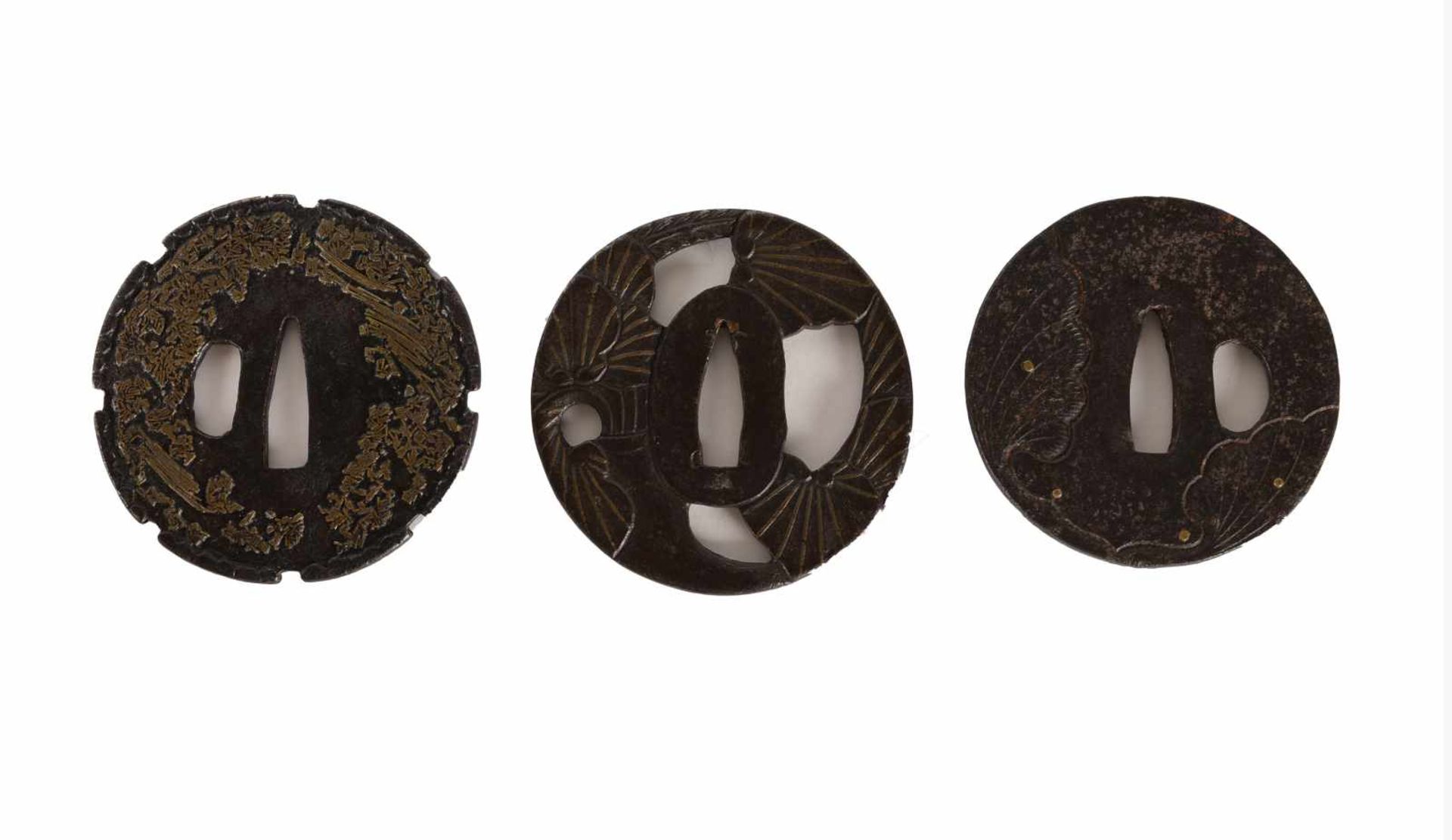Three iron tsuba with brass inlay. Japan, Edo-period.