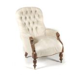 A VICTORIAN MAHOGANY AND UPHOLSTERED ARMCHAIR the padded button-back above a stuff-over seat, on
