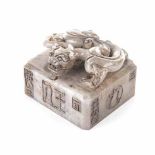 A CHINESE HARDSTONE SEAL the square seal carved with a coiled 'Chilong' grip, the sides with script,