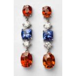 A PAIR OF MANDARIN GARNET, TANZANITE AND DIAMOND PENDANT EARRINGS each surmount claw-set with an