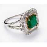 AN EMERALD AND DIAMOND RING centred with an emerald-cut emerald weighing 1.91cts, the ballerina