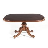 A VICTORIAN MAHOGANY TEA TABLE the rectangular moulded tilt-top on a baluster support, on restrained