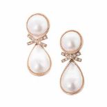 A PAIR OF MABÉ PEARL EARRINGS each surmount bezel-set with a circular mabé pearl, approximately 13,