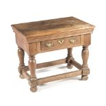 A CONTINENTAL OAK TABLE the rectangular moulded top above a long drawer, on upturned baluster