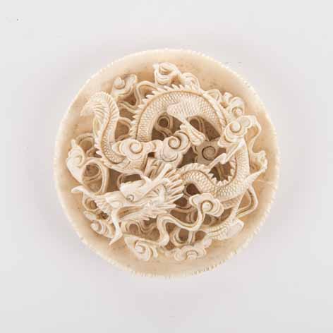 A CHINESE CARVED IVORY CIRCULAR PANEL, MEIJI PERIOD, 1868-1912 NOT SUITABLE FOR EXPORT carved in