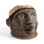 A MAKONDE HELMET MASK, MOZAMBIQUE the mask realistically carved as a head with a headdress, lip plug