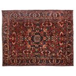 A BAKTIARI CARPET, WEST PERSIA, MODERN the madder field with a bold square black floral medallion,