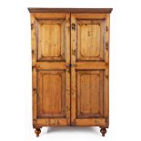 A CAPE PINE CUPBOARD, LATE 19TH CENTURY the outswept cornice above a pair of panelled doors