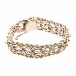 A GOLD BRACELET designed as a two rope chain centred with circular and oval openwork details
