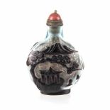 A CHINESE PURPLE OVERLAY PEKING GLASS SNUFF BOTTLE carved with a pagoda under a pine tree, mountains