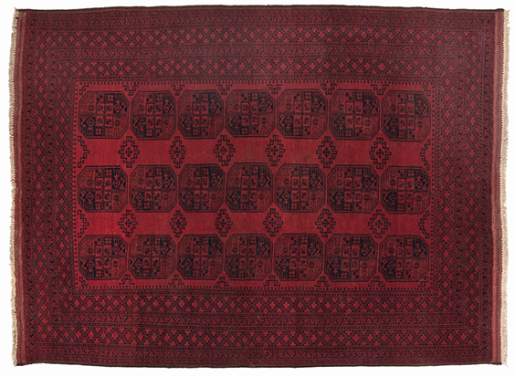 AN AFGHAN CARPET, CIRCA 1960 the red field with three rows of seven guls depicted in black and red