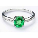 A TSAVORITE AND DIAMOND RING centred with a cushion-cut tsavorite weighing 1.32cts, the shoulders