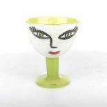 A COSTA BODA GREEN PEDESTAL BOWL painted with a face 21cm high