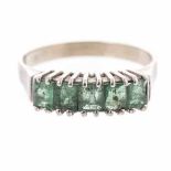 AN EMERALD AND DIAMOND RING claw-set with five emerald-cut emeralds weighing approximately 1.02cts