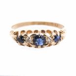 A SAPPHIRE AND DIAMOND RING the scalloped band centred with circular-cut sapphires weighing